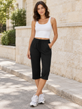 Model in black Weekend Capri and white tank top on a sunny street
